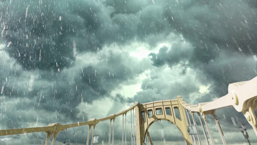 A forward driving dolly shot over the yellow Rachel Carson 9th Street Bridge over the Allegheny River in downtown Pittsburgh, Pennsylvania during a winter snowstorm.  	