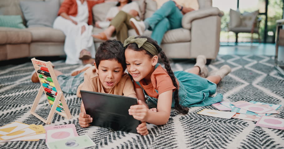 Young children, technology and tablet on floor, family and couch in home living room. Games, streaming or elearning with parents or grandparents on sofa, movies and entertainment for siblings