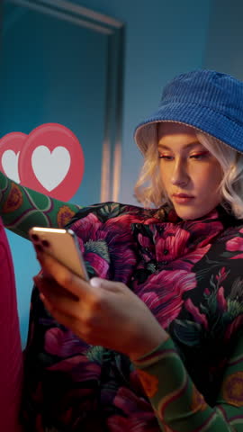 Blonde young trendy woman using her phone to interact with social media, getting followers, likes, emoji feedback Royalty-Free Stock Footage #3453306291
