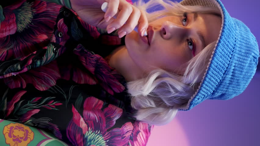 Portrait of woman dressed in stylish clothes smoking at studio. Mental health concept