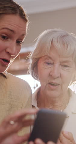 Phone, conversation and woman with elderly mom helping on social media, app or internet. Discussion, technology and female person talking, bonding and explaining cellphone to senior mother at home.