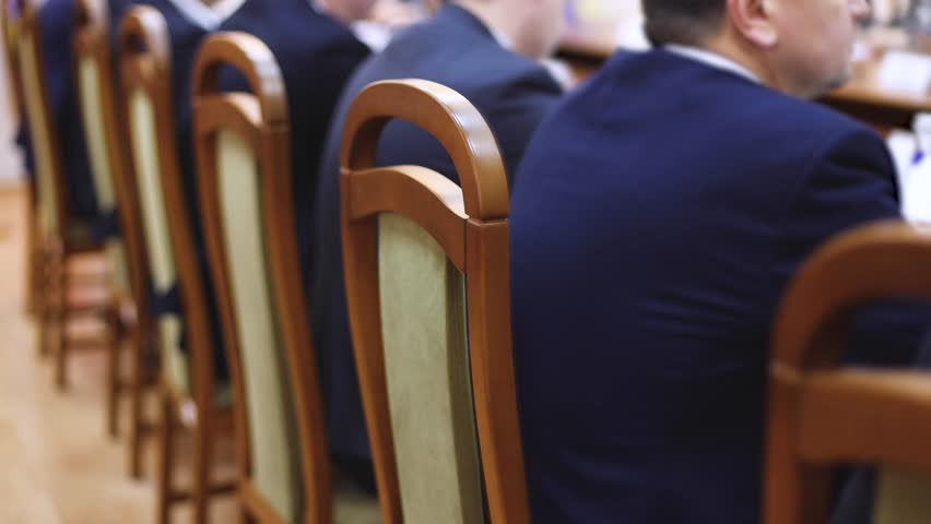 Group of men in business suits talking and discussing at conference, politicians and entrepreneurs debate, networking and negotiate, businessmen have dialog conversation on a forum, panel discussion