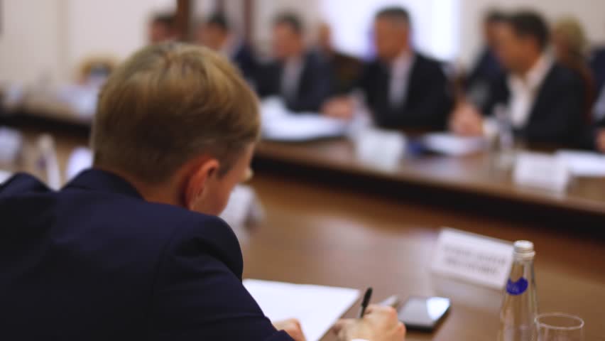 Group of men in business suits talking and discussing at conference, politicians and entrepreneurs debate, networking and negotiate, businessmen have dialog conversation on a forum, panel discussion