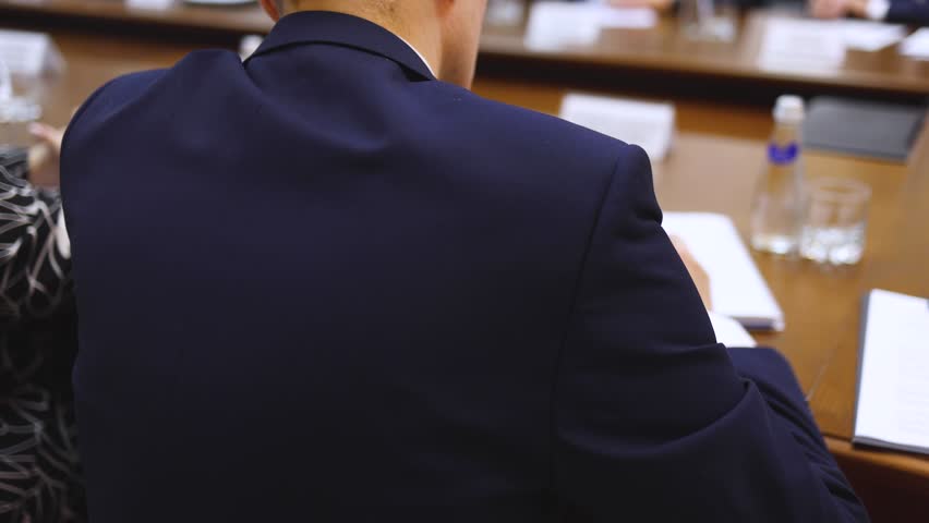 Group of men in business suits talking and discussing at conference, politicians and entrepreneurs debate, networking and negotiate, businessmen have dialog conversation on a forum, panel discussion