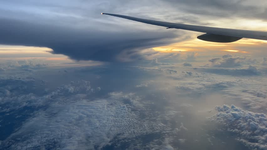a timelapse footage recorded from inside the plane shows thick white clouds Royalty-Free Stock Footage #3453501589