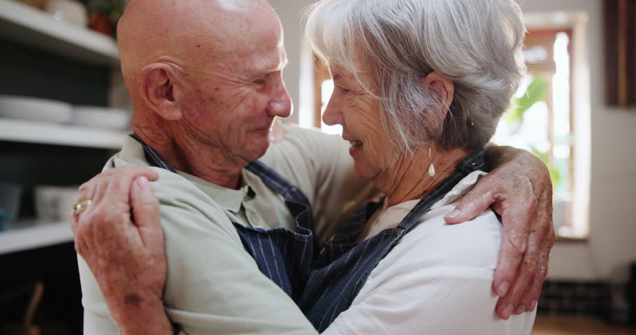Senior, couple and hug in kitchen with love, support and care in marriage and retirement. Elderly, man and woman embrace with kindness or gratitude for cooking in home together with happiness Royalty-Free Stock Footage #3453505175