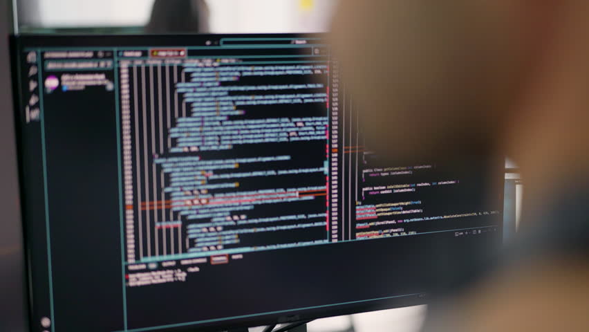 A monitor shows an intricate array of code, highlighting the complex tasks that developers handle in the realm of software engineering and programming. Royalty-Free Stock Footage #3453548091