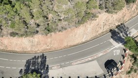 Aerial view from drone of road in the middle of the green mountain and seashore, 4K 