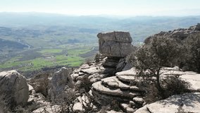 Aerial drone footage captures the stunning landscape of Torcal de Antequera, focusing on the unique rock formation known as 