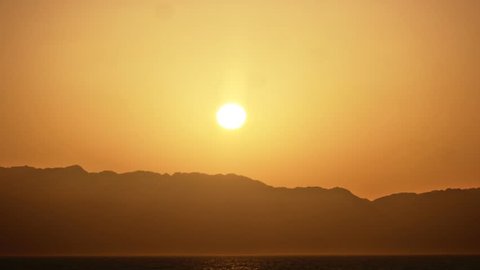 Timelapse of sunrise over the hills of saudi arabia from dahab, egypth. In the middle there is the read sea. (2017)