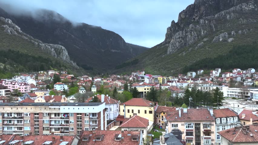 Drone shot of a small village next to a mountain