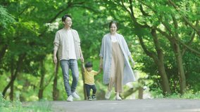 family walking in the park holding hands - Powered by Shutterstock - Get 15% off with code: PIKWIZARD15