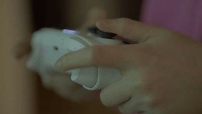 Close-up of Teenage Gamer Hands Playing Video Game on Console Using Joystick. Child Playing on Game Controller in Computer Video Game. Hands Person Playing Video Games on Console With Gamepad at Home.