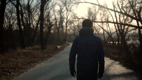 Confidence Man Walking On Road At Sunrise. Lonely Walker Guy Rest On Holiday. Man Walking On Park. Businessman Relaxing Fall. Male In  Parka Walk On Autumn Road. Warm December Evening. Tree No Leaves - Powered by Shutterstock - Get 15% off with code: PIKWIZARD15