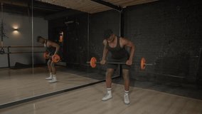 Active motivated sporty muscular build African man doing weightlifting training, practicing barbell row exercise , strengthening upper body and back muscles during indoor workout. - Powered by Shutterstock - Get 15% off with code: PIKWIZARD15