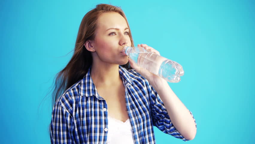 pretty woman drinking water from bottle