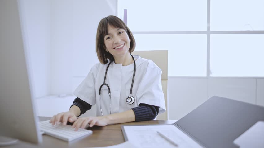 A subjective view captures the compassionate interaction between a caring doctor and a patient as the doctor writes a prescription, emphasizing empathy and personalized care Royalty-Free Stock Footage #3453721003