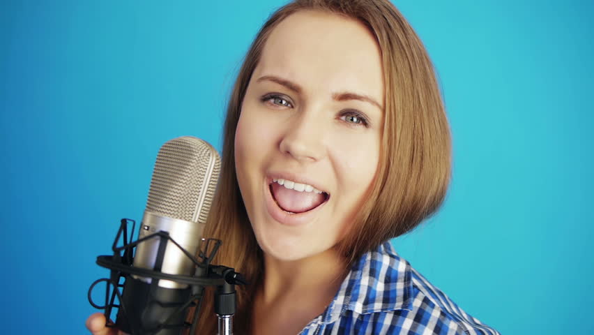 young woman singing a song at studio