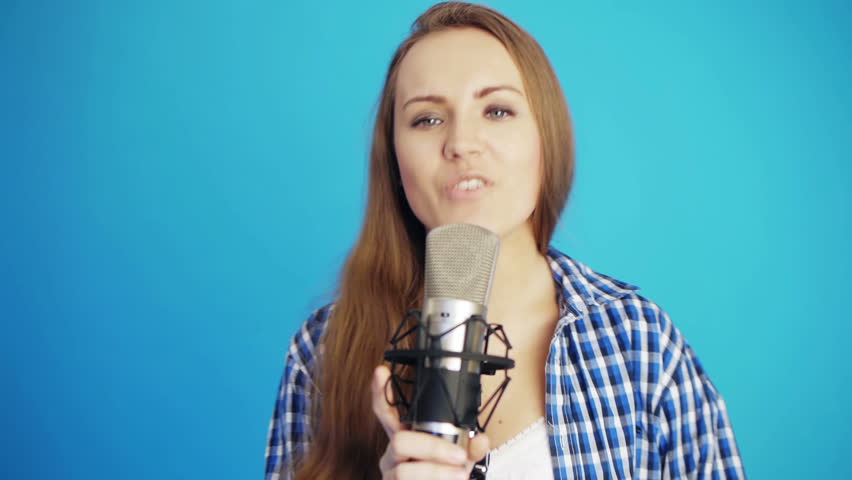 attractive woman singing song at studio