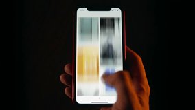Close-up time-lapse of male hand scrolling social networks on smartphone screen, network scroll mobile phone screen at night, blurred fast motion, pov cellphone scrolling apps surf internet web pages - Powered by Shutterstock - Get 15% off with code: PIKWIZARD15