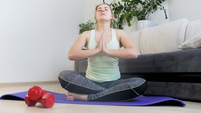 4k video of young woman relaxing in yoga pose after exercising on fitness mat