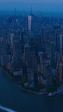 Vertical Screen: Evening Aerial View of Lower Manhattan Architecture. Panoramic Footage of Financial District from a Helicopter. Office Buildings Next to Water Transportation in Hudson and East Rivers