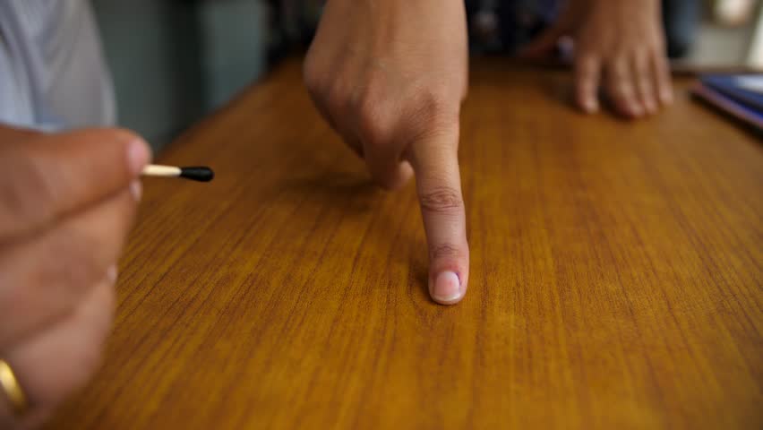 An electoral officer applying electoral stain ink on the index finger - general elections. Electoral ink used during polls in India - assembly elections, right to vote, indelible ink, electoral sta... Royalty-Free Stock Footage #3453878535