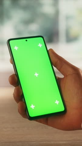 Vertical Screen: Creative Worker Checking a Social Network Post on Smartphone with Mock-Up Green Screen Display. Video Template with Placeholder for Business Advertising and Motivational Content Royalty-Free Stock Footage #3453888513