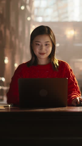 Vertical Screen: Focused Asian Student Studying in a Traditional Library. Young Female Using Laptop Computer to Work on an University Research Project, Read Academic Books and Journals Online Royalty-Free Stock Footage #3453898333