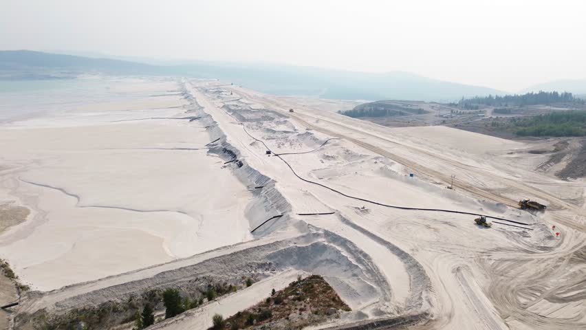 Aerial Drone Reveals Highland Valley Copper Mine Tailing Pond Viewpoint Over Sandy Terrain and Surrounding Landscape, Canada.