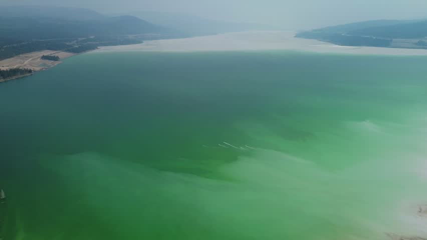 Aerial Drone Reveals Highland Valley Copper Mine Tailing Pond Viewpoint Over Turquoise Lake and Surrounding Landscape in Canada.