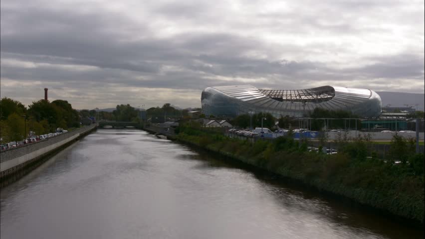 Cloudy sky over Aviva Stadium by the river, Dublin, timelapse