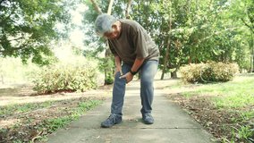Senior man exercising in the park walking on the concrete floor has sudden knee pain osteoarthritis relieves the symptoms with gentle massage. - Powered by Shutterstock - Get 15% off with code: PIKWIZARD15