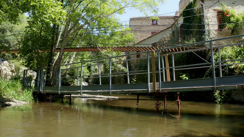 Aerial shot of an operational paper mill in the Black Mountain, north of Carcassonne, in the small village of Brousses et Villaret. Seen from a shaded path alongside a small stream.