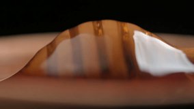 Natural organic honey dripping, pouring from wooden honey dipper close up. UHD 4k macro shot video - Powered by Shutterstock - Get 15% off with code: PIKWIZARD15