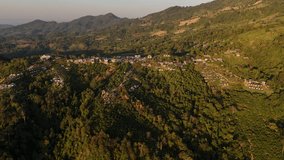 Aerial video of a village in a beautiful valley and forest.