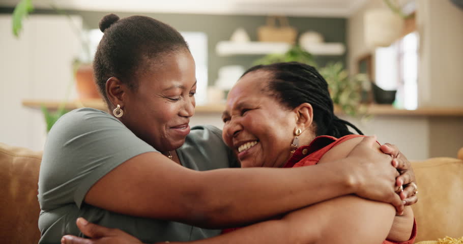 Sofa, hug and happy senior mother with woman for loving relationship, bonding and relax together. Family, home and African mom with daughter laugh on couch for love, care and embrace in living room Royalty-Free Stock Footage #3454079749