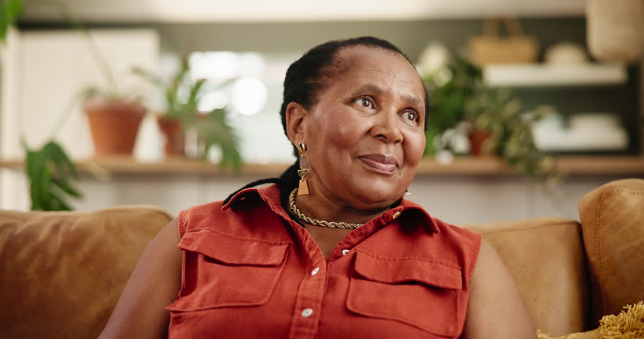 Face, happy and black woman in home living room to relax on couch in apartment alone in Kenya. Portrait, lounge and smile of African female person, positive and cheerful mature lady in causal clothes