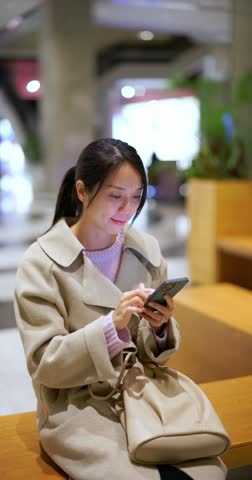 Vertical view of woman use of mobile phone in shopping mall Royalty-Free Stock Footage #3454122723