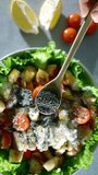 chia seeds falling slow motion, close up video. healthy caesar salad cooking. tomato, chicken. cheese, crunchy croutons, romaine lettuce, olive oil, lemon