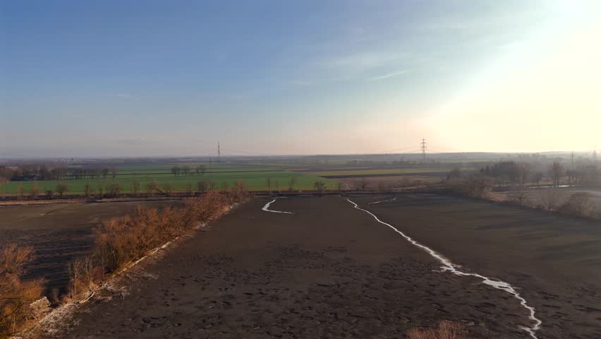Ismaninger Speichersee Munchen, Bayern, Deutschland. Reservoir and water channels in spring during sunny weather. Water storage system serves as stage in biological treatment of Munich waste water. 