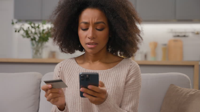 Stressed displeased African american woman female buyer ethnic customer girl pay online service with bank credit card mobile phone order delivery disappointed failure banking app error money balance Royalty-Free Stock Footage #3454206827