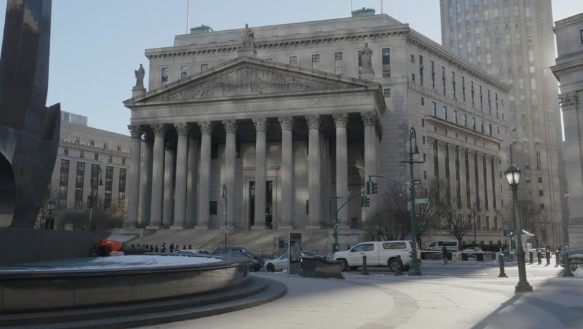 Handheld shot of The New York County Supreme Court building.