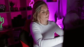 Caucasian woman using headphones in a neon-lit gaming room at night