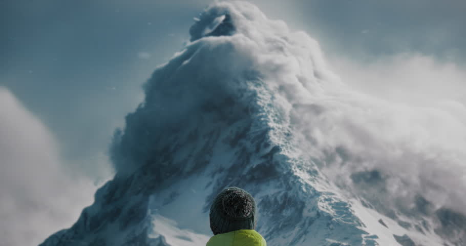 A Man Standing On Top Of A Snow Covered Mountain Looking At A Large Cloud Snowy Mountain Peak Panoramic Photography Mountains
