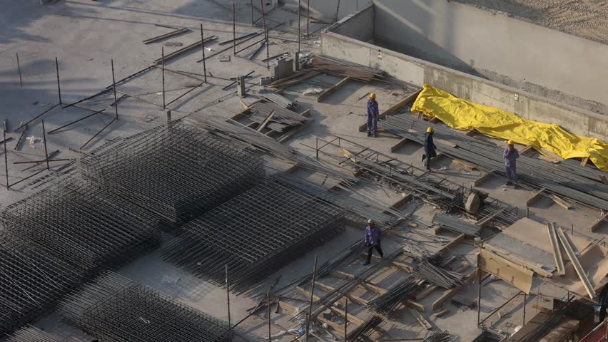 Foundation laying. Unrecognisable Construction workers walking on a construction site with a metal Reinforcement Dubai Singapore UAE United Arab Emirates Reinforcement Construction in Arab countries