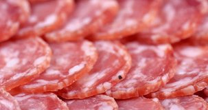Close up video of Salami sausage slices background. Slices of smoked sausage. Food background