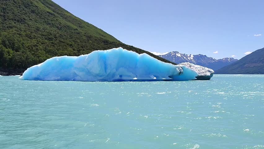 Huge iceberg calved from the Perito Moreno glacier in Argentina. Huge iceberg surrounded by beautiful landscape in southern Argentina. Huge piece of ice in the glacier lagoon