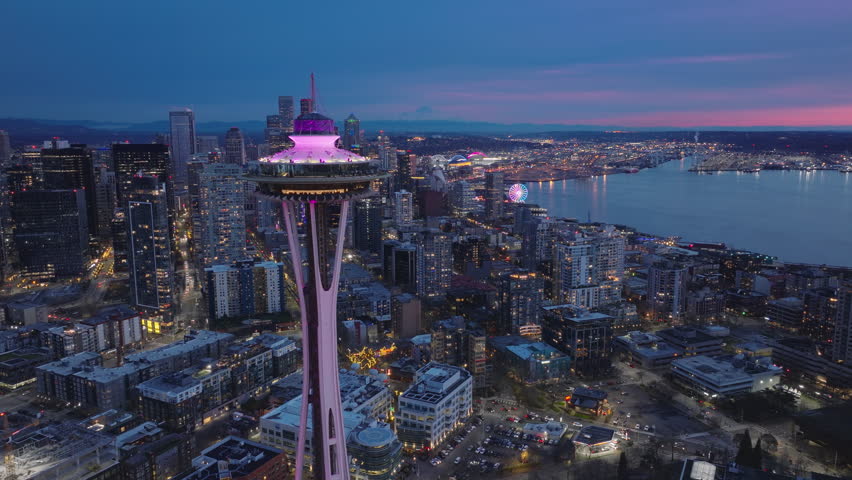 Breathtaking drone shot of business city USA 4K. Aerial around observation tower with scenic Seattle downtown on motion background. Closeup Seattle landmark at cinematic pink sunset with beautiful sky