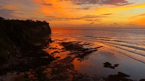 Aerial shot of sunset in Uluwatu beach. Uluwatu beach has the best sunsets in Bali. - Powered by Shutterstock - Get 15% off with code: PIKWIZARD15